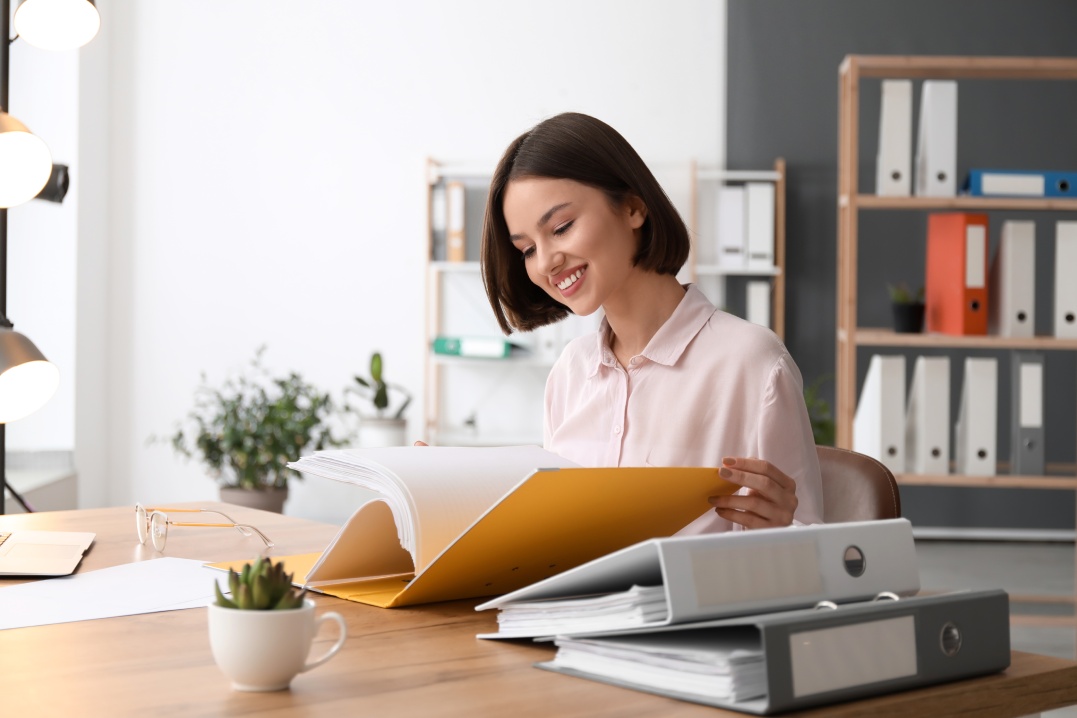 Young,Woman,Working,With,Documents,In,Office